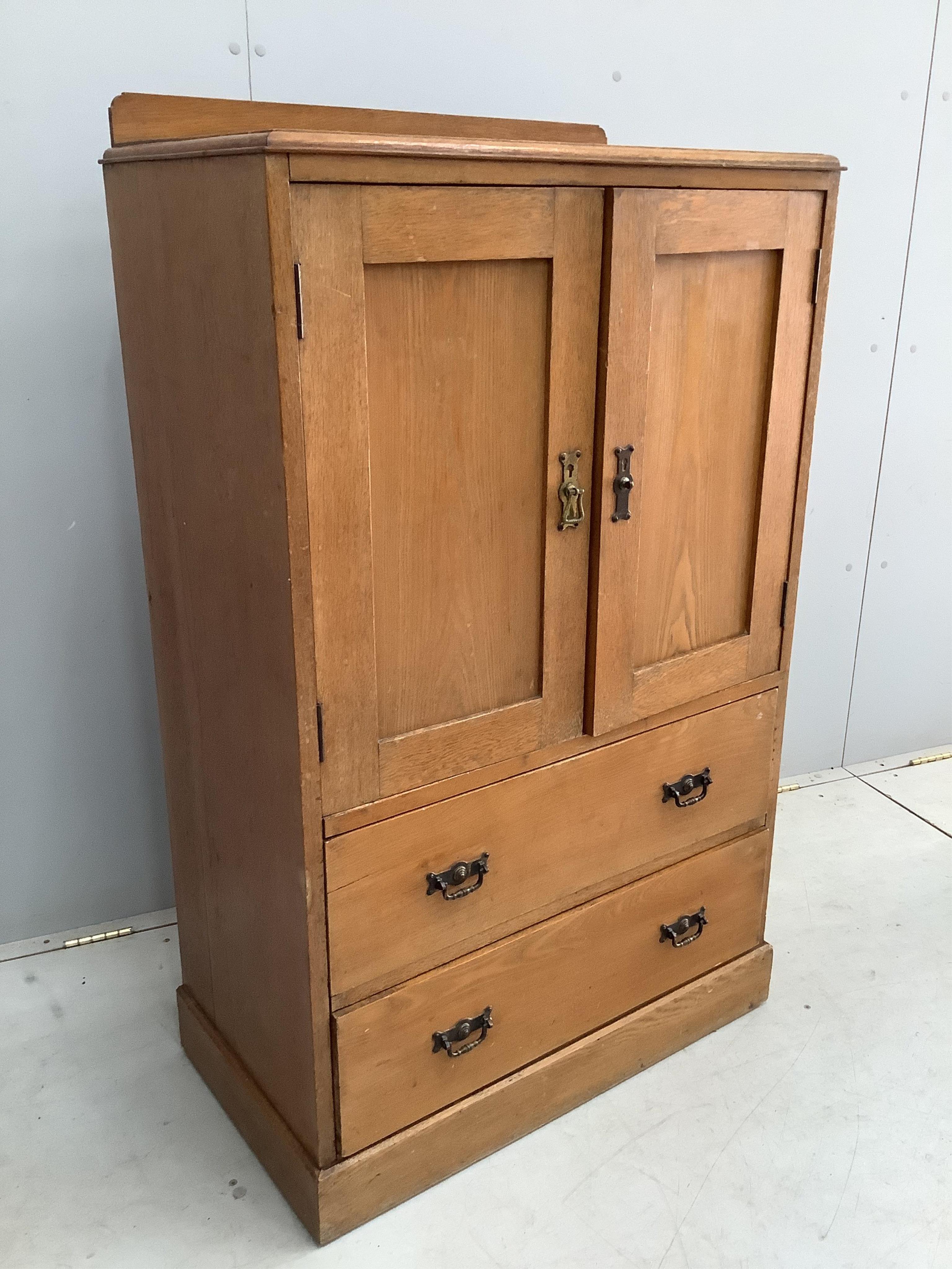 An early 20th century small oak press cupboard, width 75cm, depth 42cm, height 124cm